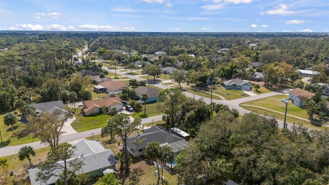 bird's eye view featuring a residential view and a wooded view