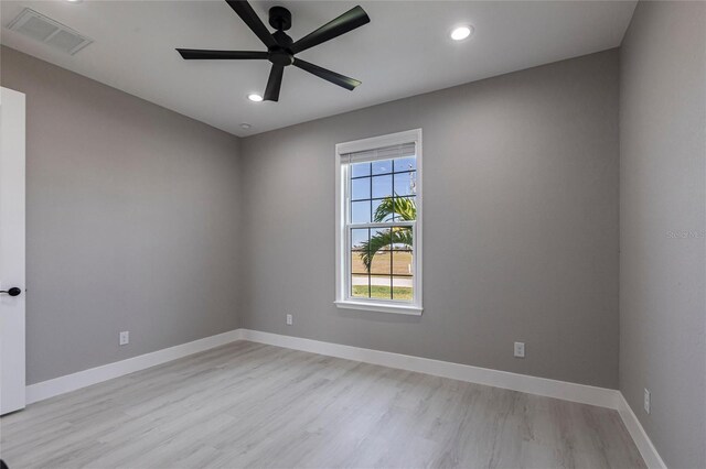 unfurnished room featuring recessed lighting, visible vents, light wood-style flooring, and baseboards