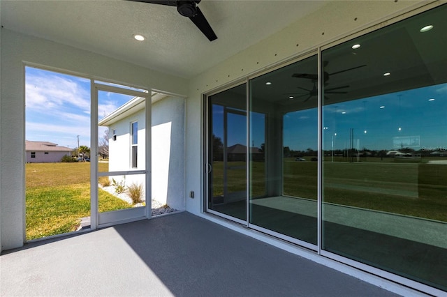 sunroom / solarium featuring ceiling fan