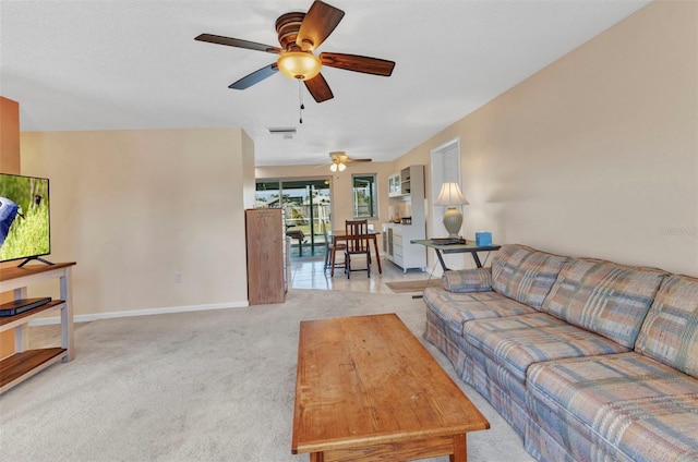 carpeted living room with baseboards and ceiling fan