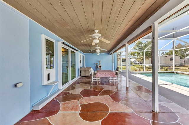 view of patio / terrace with a lanai, an outdoor pool, and a ceiling fan