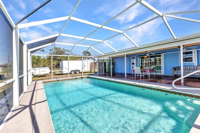 view of swimming pool featuring a fenced in pool, a patio, and glass enclosure