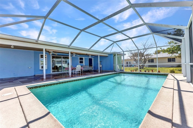 outdoor pool featuring a lanai, a patio, and ceiling fan