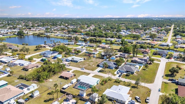 drone / aerial view featuring a residential view and a water view