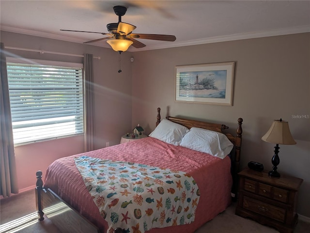 bedroom featuring carpet, ornamental molding, and a ceiling fan