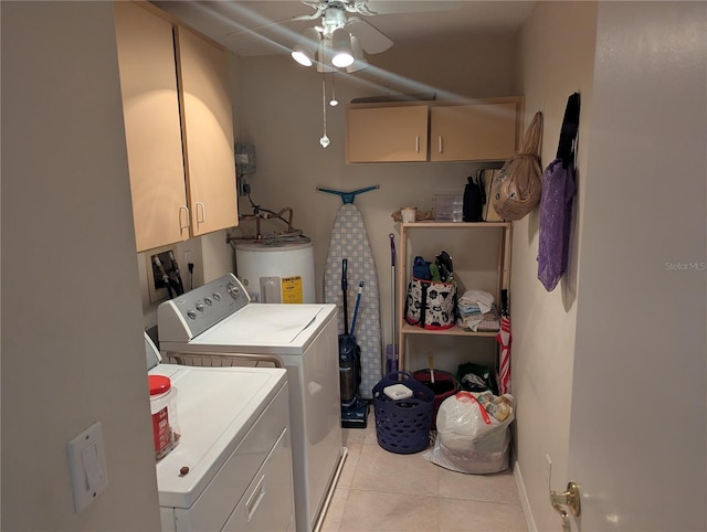 washroom featuring electric water heater, washing machine and dryer, cabinet space, light tile patterned flooring, and ceiling fan