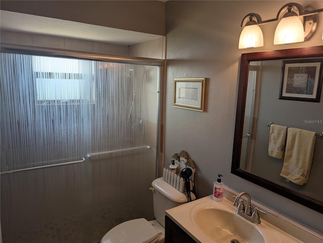 full bathroom with toilet, a shower stall, vanity, and a textured wall