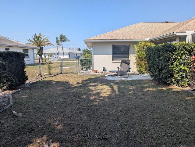 view of yard with a patio area, a gate, and fence