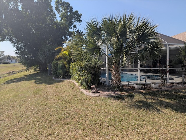 view of yard featuring an outdoor pool and glass enclosure