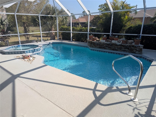 view of pool featuring a patio area, glass enclosure, and a pool with connected hot tub