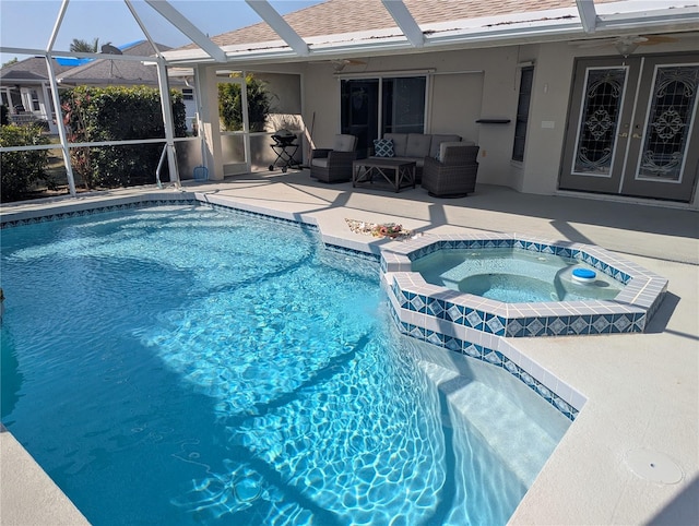 outdoor pool with glass enclosure, an in ground hot tub, a patio area, and an outdoor hangout area