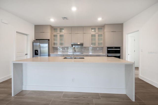 17261 Naiad Ct, Punta Gorda, FL 33955 - kitchen with appliances with stainless steel finishes, modern cabinets, a sink, a large island, and light countertops