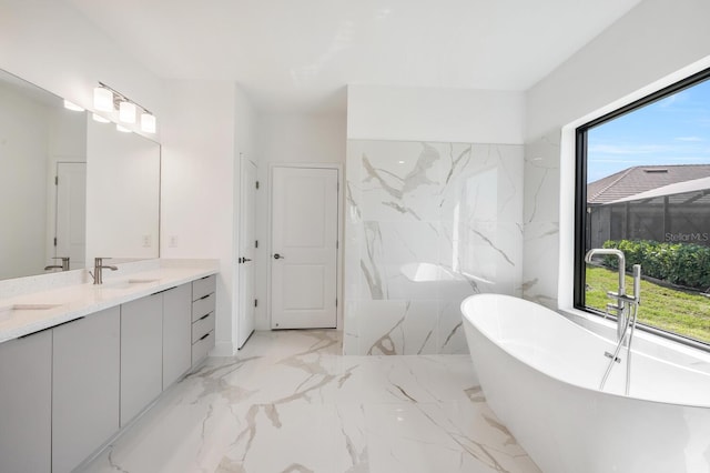 17261 Naiad Ct, Punta Gorda, FL 33955 - bathroom with plenty of natural light, a freestanding bath, double vanity, and marble tiled floors