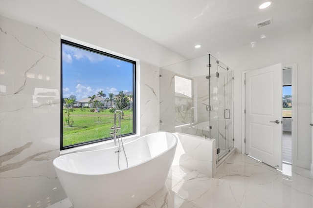 17261 Naiad Ct, Punta Gorda, FL 33955 - bathroom featuring marble tiled flooring, a soaking tub, recessed lighting, and a marble finish shower