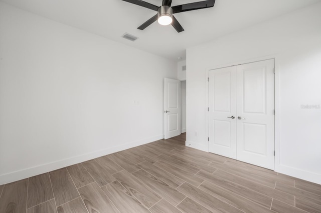 17261 Naiad Ct, Punta Gorda, FL 33955 - unfurnished bedroom featuring light wood finished floors, baseboards, a closet, and a ceiling fan