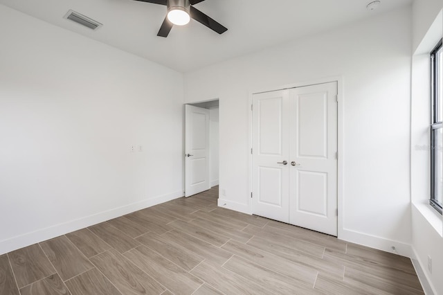 17261 Naiad Ct, Punta Gorda, FL 33955 - unfurnished bedroom with baseboards, light wood-style floors, a closet, and a ceiling fan