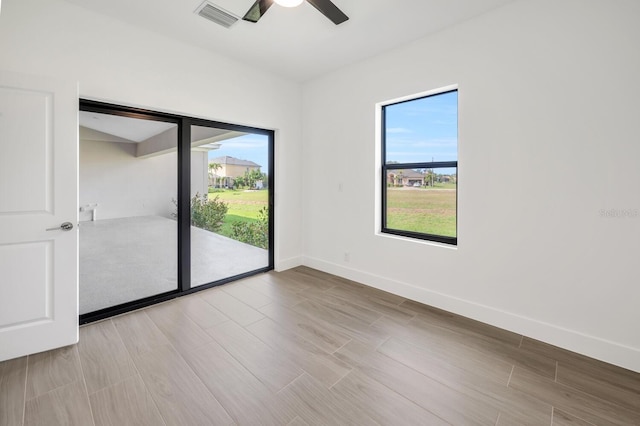 17261 Naiad Ct, Punta Gorda, FL 33955 - empty room with a ceiling fan, wood finished floors, and healthy amount of natural light