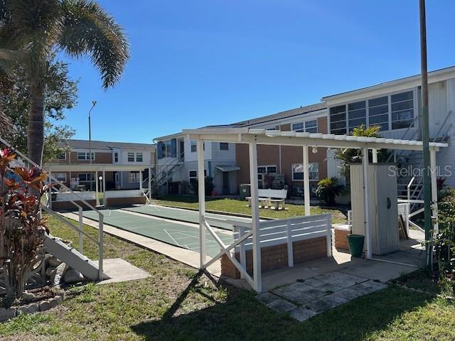 view of home's community featuring shuffleboard