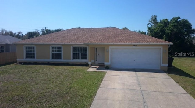 ranch-style home featuring a garage, stucco siding, driveway, and a front yard