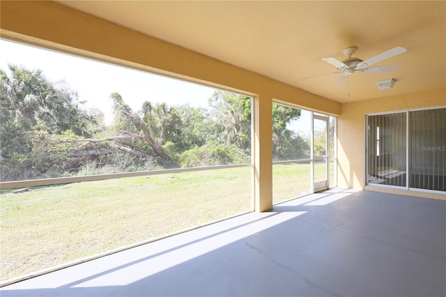 unfurnished sunroom with ceiling fan