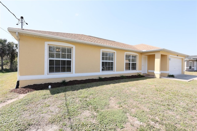 view of front facade with a garage, stucco siding, a front yard, and roof with shingles