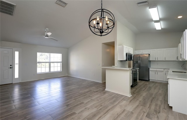 kitchen with a sink, visible vents, appliances with stainless steel finishes, and open floor plan