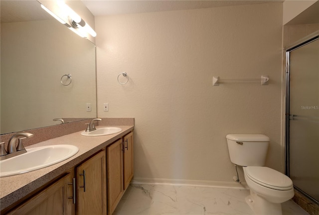 bathroom with toilet, baseboards, marble finish floor, and a sink