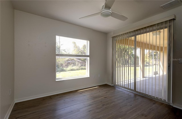 spare room featuring visible vents, baseboards, wood finished floors, and a ceiling fan