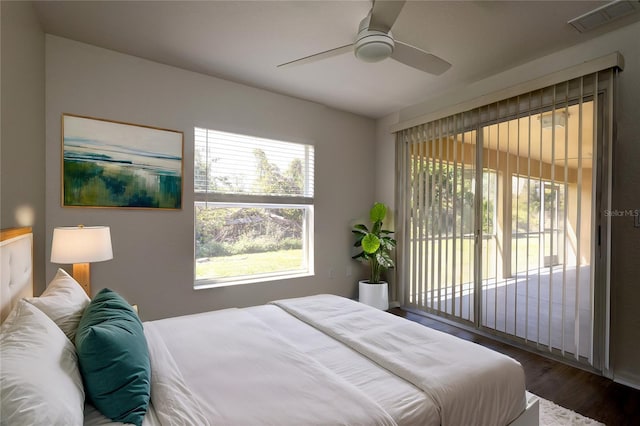 bedroom featuring visible vents, wood finished floors, a ceiling fan, and access to outside