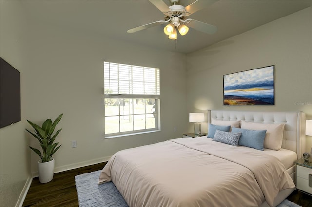 bedroom featuring ceiling fan, baseboards, and wood finished floors