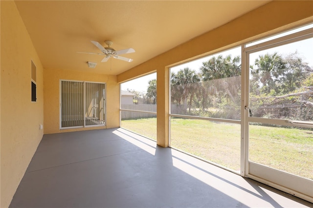 unfurnished sunroom with visible vents and ceiling fan