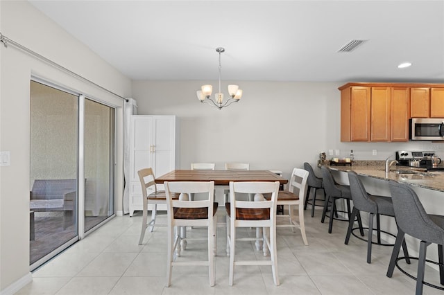 dining space featuring light tile patterned floors, recessed lighting, visible vents, and a chandelier