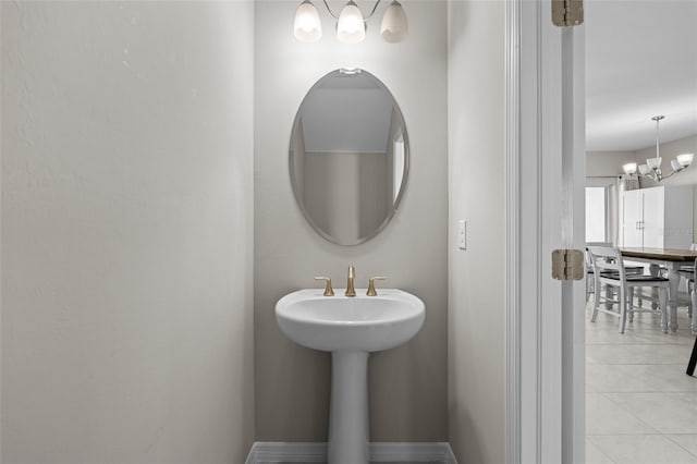 bathroom featuring tile patterned floors and a chandelier