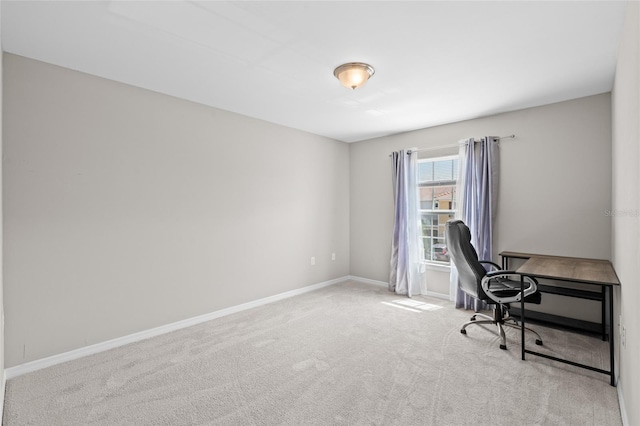 carpeted home office featuring baseboards