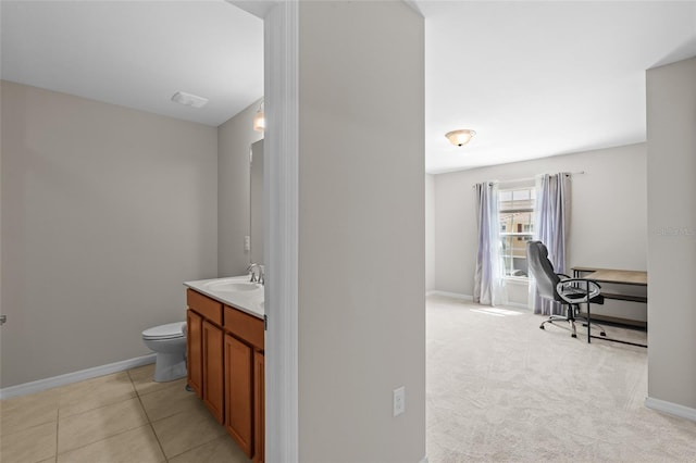 bathroom with vanity, tile patterned floors, toilet, and baseboards