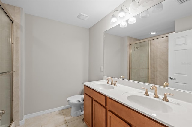 full bathroom featuring tile patterned floors, a tile shower, and a sink