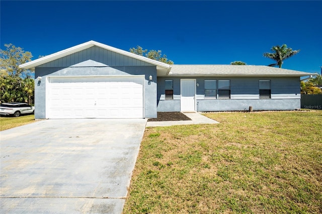 ranch-style house with an attached garage, driveway, and a front yard