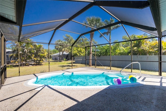 view of swimming pool featuring glass enclosure, a patio, and fence