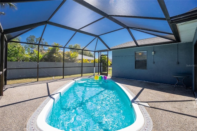 view of swimming pool with a patio area, a fenced in pool, a lanai, and fence