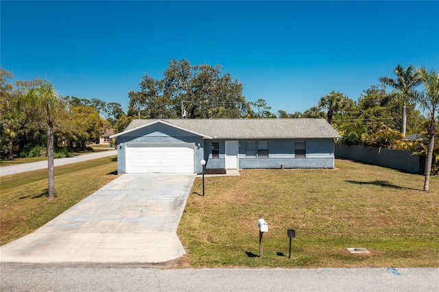 view of front of property featuring an attached garage, driveway, a front lawn, and fence