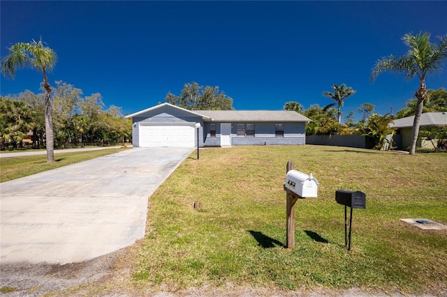 view of front of home with a garage, a front yard, and driveway