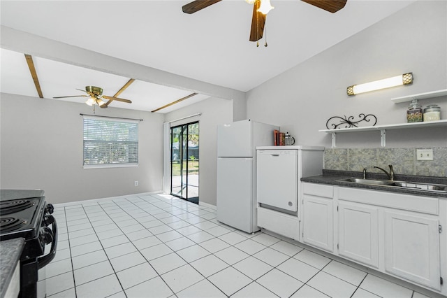 kitchen with a sink, electric range, dark countertops, and a ceiling fan