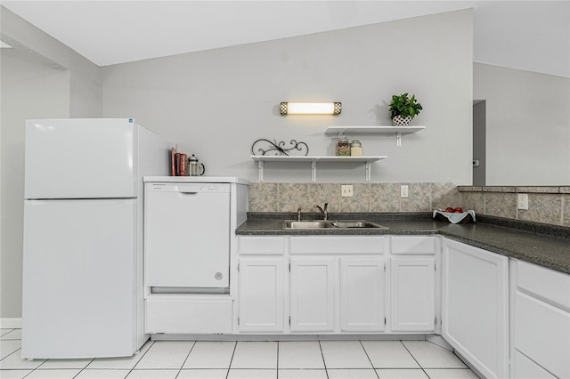 kitchen featuring white appliances, dark countertops, open shelves, and a sink