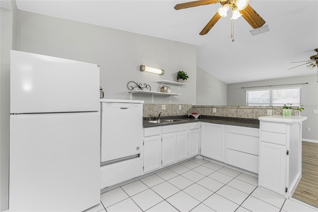 kitchen featuring white appliances, a ceiling fan, visible vents, a sink, and white cabinetry