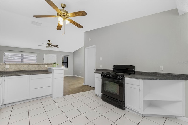 kitchen featuring visible vents, open shelves, dark countertops, white cabinetry, and black gas stove