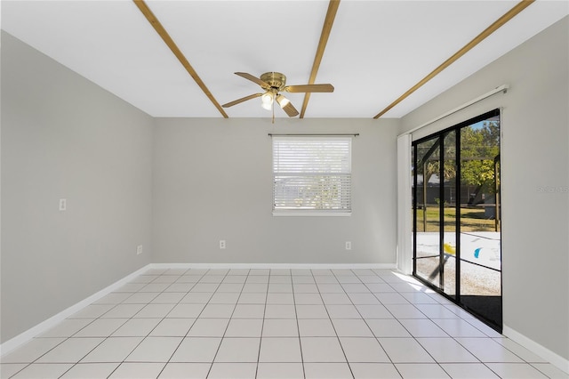 spare room with light tile patterned floors, baseboards, and ceiling fan