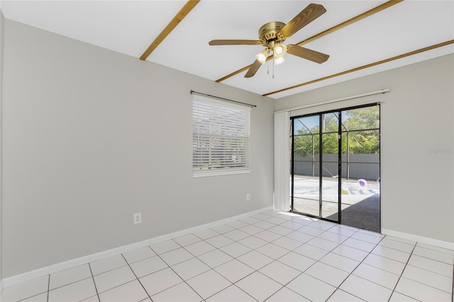 unfurnished room with light tile patterned flooring, baseboards, and ceiling fan