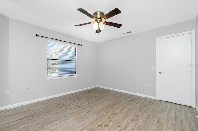 unfurnished room featuring visible vents, baseboards, a ceiling fan, and light wood finished floors