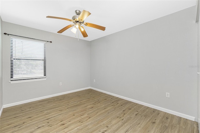 unfurnished room featuring baseboards, light wood-style floors, and a ceiling fan