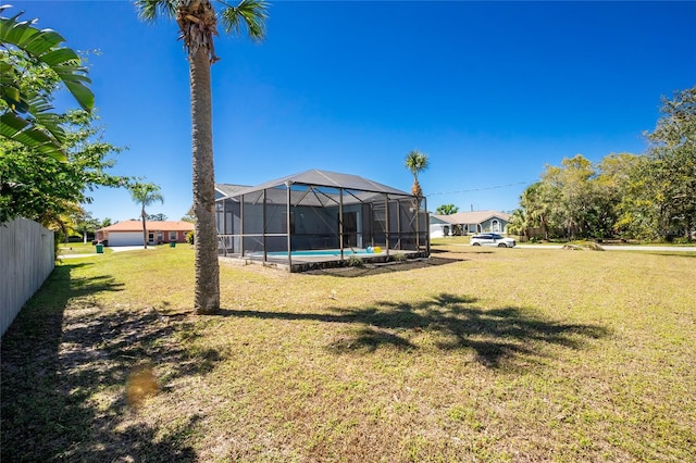 view of yard with a lanai and an outdoor pool